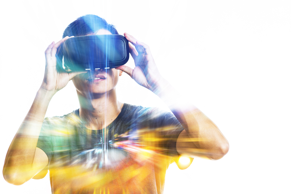 Double exposure of man using the virtual reality headset